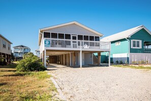 A two-story building with a covered front porch and a balcony. - Changes In Attitudes- Wireless internet access, screened porch and close to beac (Oak Island)