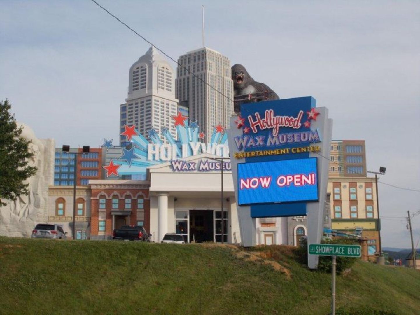 The Hollywood Wax Museum entrance with a large sign indicating it is now open.