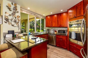 Enjoy cooking in this well-equipped kitchen with a large island, double oven, and dishwasher.