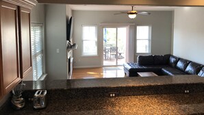 A modern kitchen with granite countertops, a built-in oven, and a toaster.
