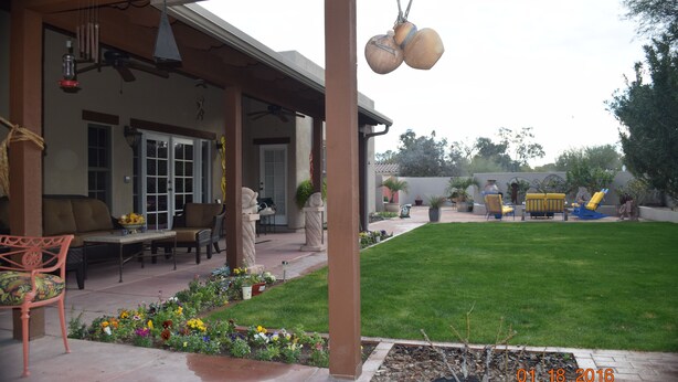 A covered patio area with outdoor furniture, a lawn, and a date stamp of 01-18-2016. - 1/2 mile from large bike/walk path  and 3 miles from the U of A (Tucson)