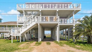 A multi-story building with balconies and a covered walkway.