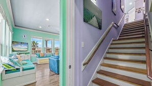 A staircase leading to a landing with a view of a balcony.