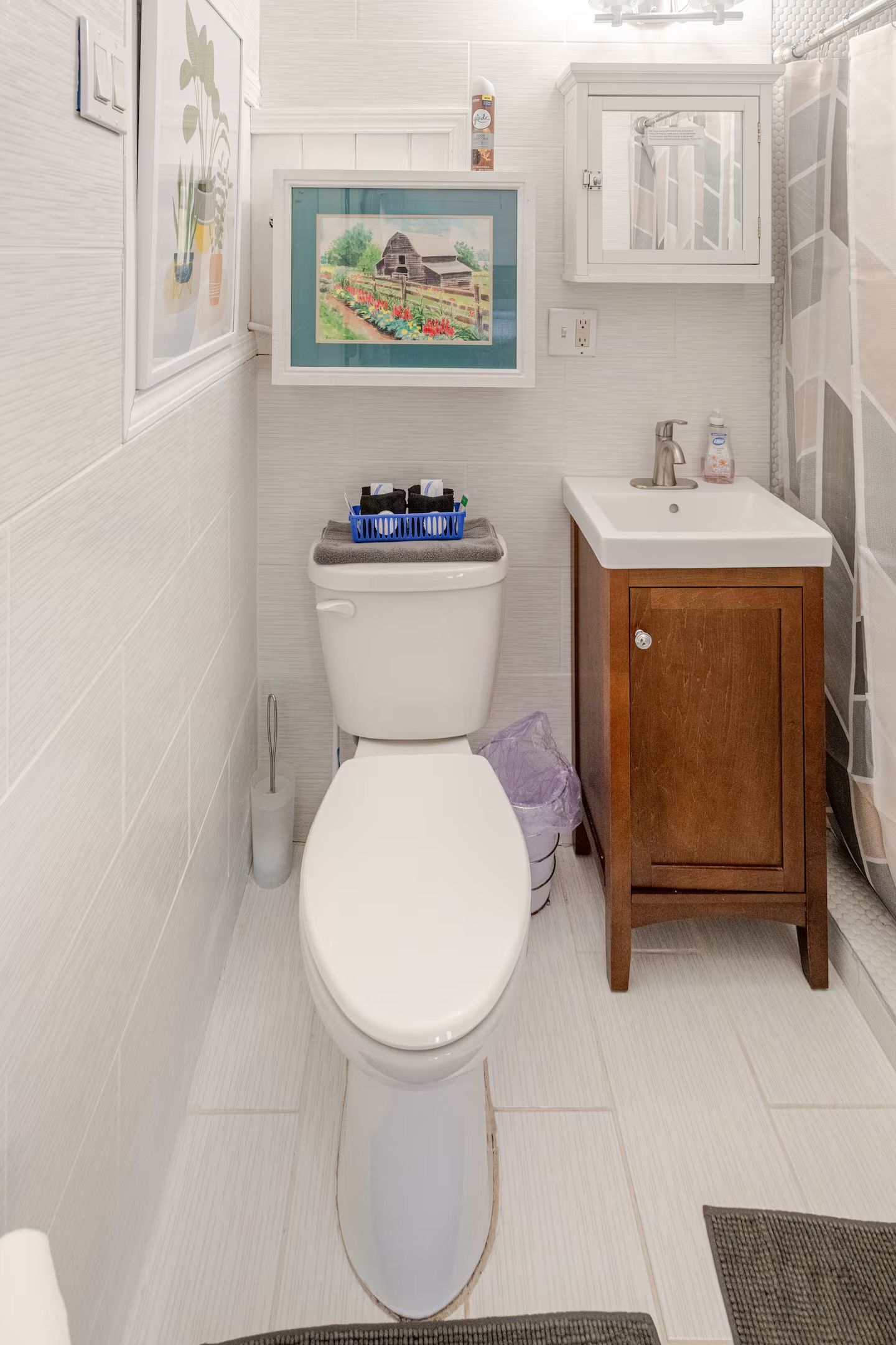 Une salle de bain avec des toilettes, un lavabo et un meuble de rangement.