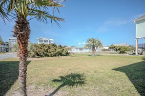 A residential area with houses, a palm tree, and a water tower.