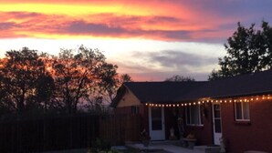 A backyard with a house, a wooden fence, and a tree. - Fantastic Denver Location! 5 mins from every major highway! Mountain & Lake View (Denver)