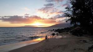 A beach with a sunset, rocky shoreline, and a few people walking. - Maui Vista #2-101 Ground Floor, Pickle Ball Courts, Near Kamaole Beach Park (Kihei)