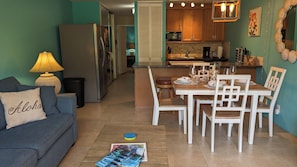 Cozy living space with a sofa, kitchenette, and dining area.