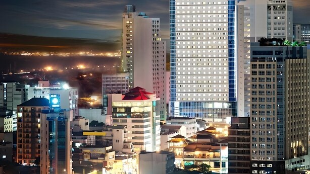A high-rise hotel with a prominent sign, multiple floors, and a modern architectural design.