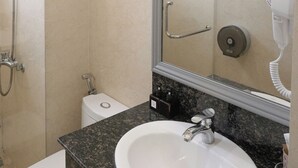 A bathroom with a sink, mirror, towel rack, and shower. - Ngoc Trai Vang Hotel (Xuan Huong - Da Lat)