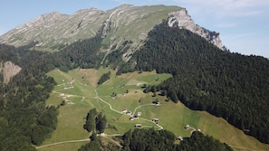 A mountainous landscape with scattered houses and clear paths.