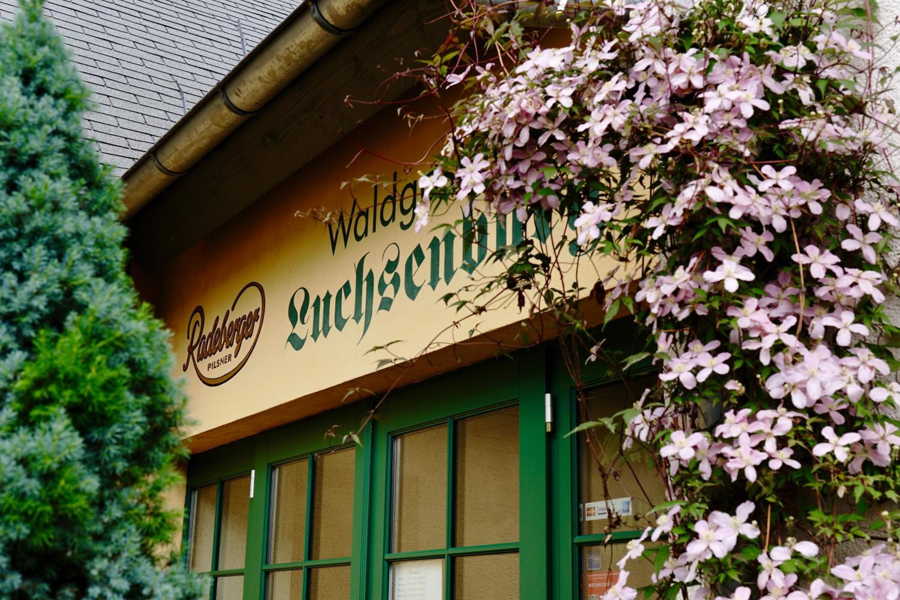 A building with a sign reading "Waldgutschen" and "Radeberger Pilsner".