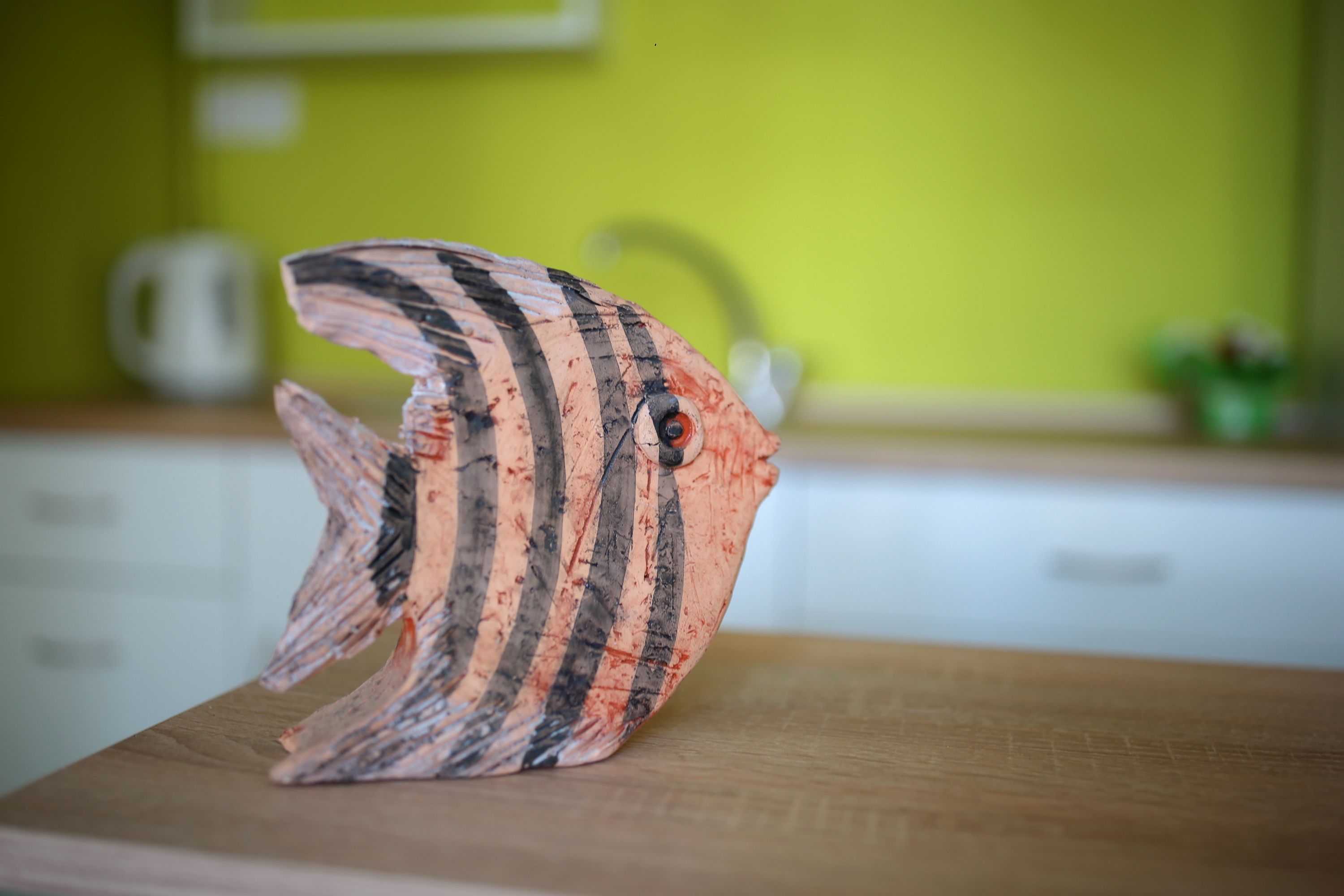 A fish-shaped object on a wooden surface.
