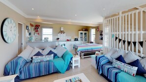 A cozy living room with a sofa set, a dining table, and a kitchen area in the background. - Captain's Reach St. Francis Bay (Saint Francis Bay)