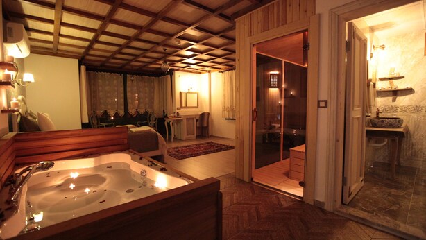Un baño con una bañera grande, una zona de ducha y un tocador con lavamanos.