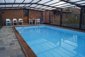 Seasonal outdoor pool, open 10:00 AM to 9:00 PM, pool loungers