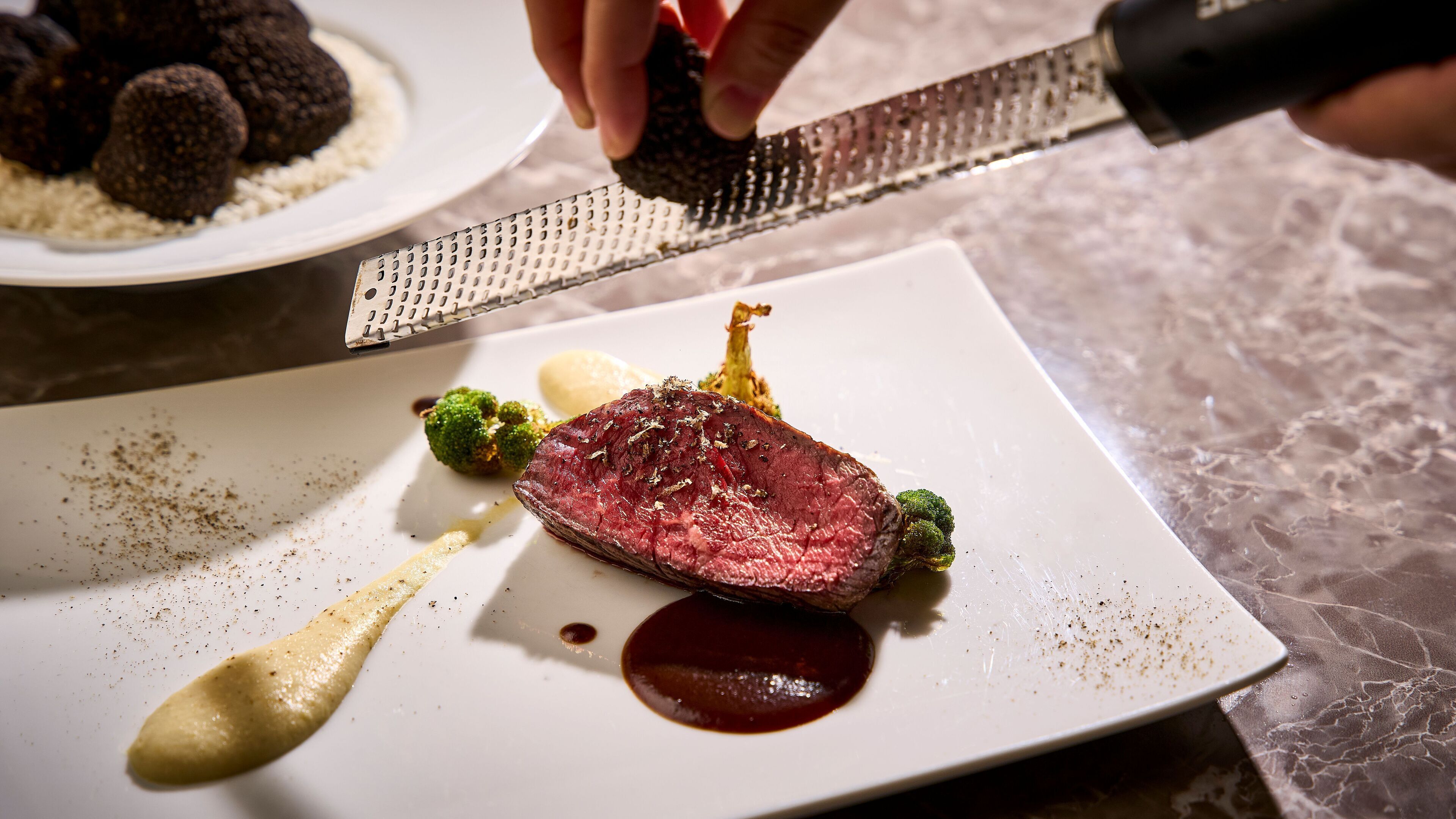 A plate with a steak, broccoli, and a sauce.