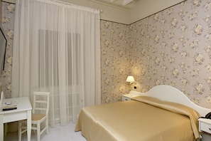 Un dormitorio con cama, escritorio y silla.