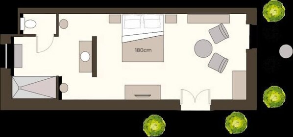 A hotel room layout with a bed, seating area, and a small kitchenette. - Les Loges de Saint Eloi (Pontlevoy)