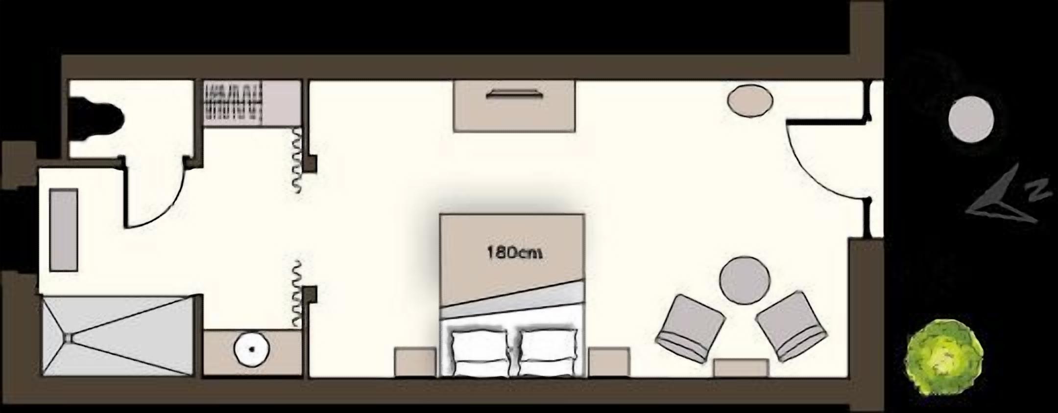 A floor plan of a hotel room with a bed, a desk, a chair, a wardrobe, and a bathroom.