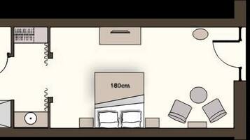 A floor plan of a hotel room with a bed, a desk, a chair, a wardrobe, and a bathroom.
