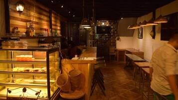 A restaurant interior with a counter, display cases, and a seating area.