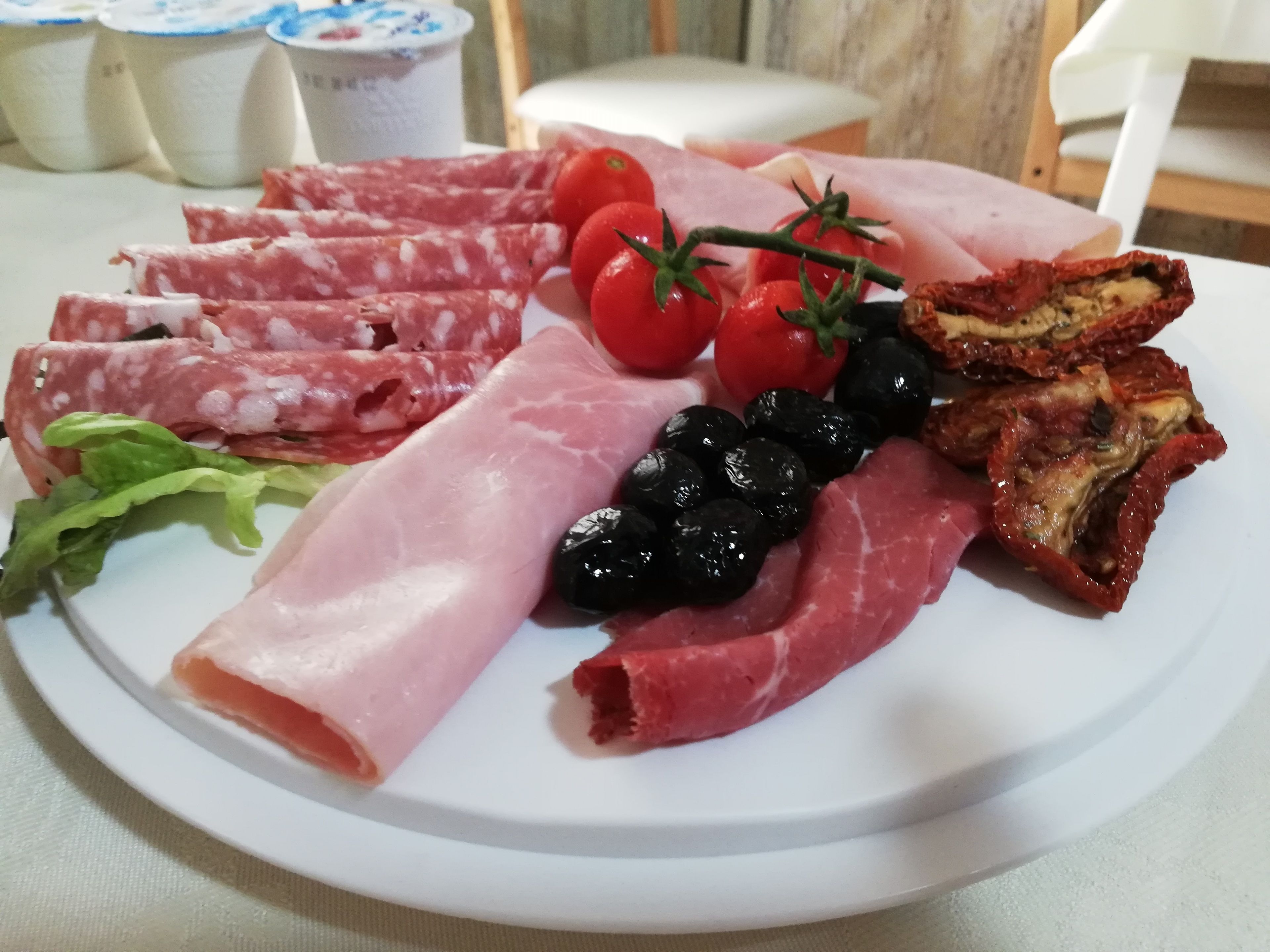 A plate of assorted meats and vegetables.