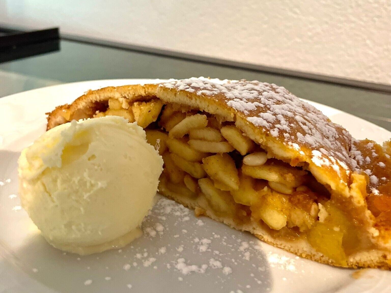 Ein Dessert mit Gebäck und einer Kugel Eis auf einem Teller.