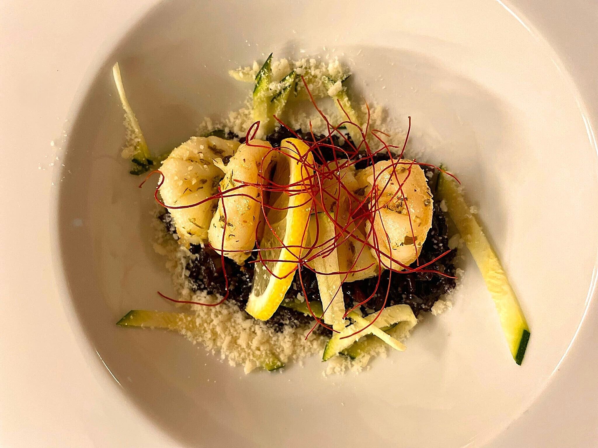 A plate of food with a variety of vegetables and garnishes.