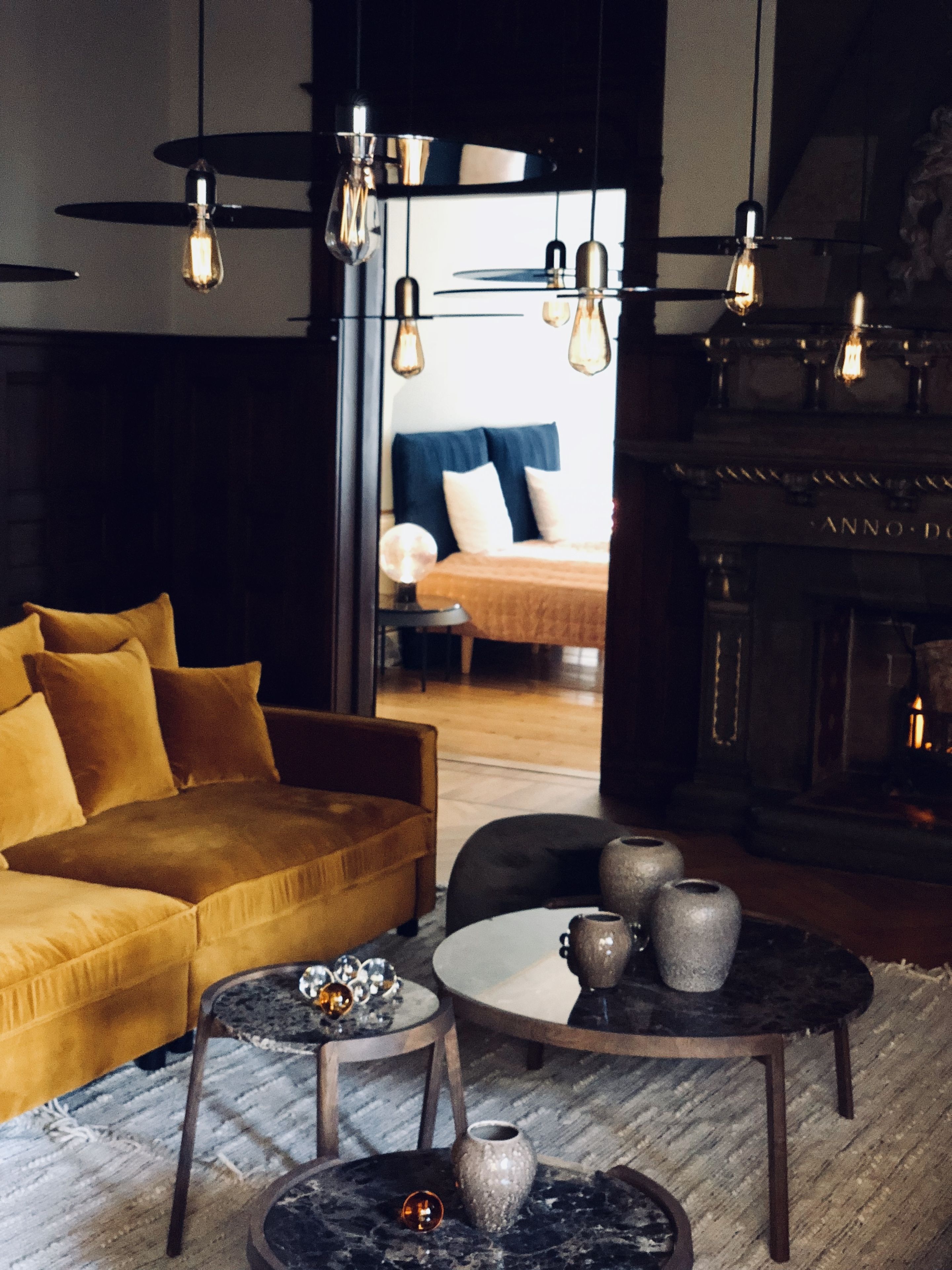 A modern living room with a sofa, coffee table, and decorative items.