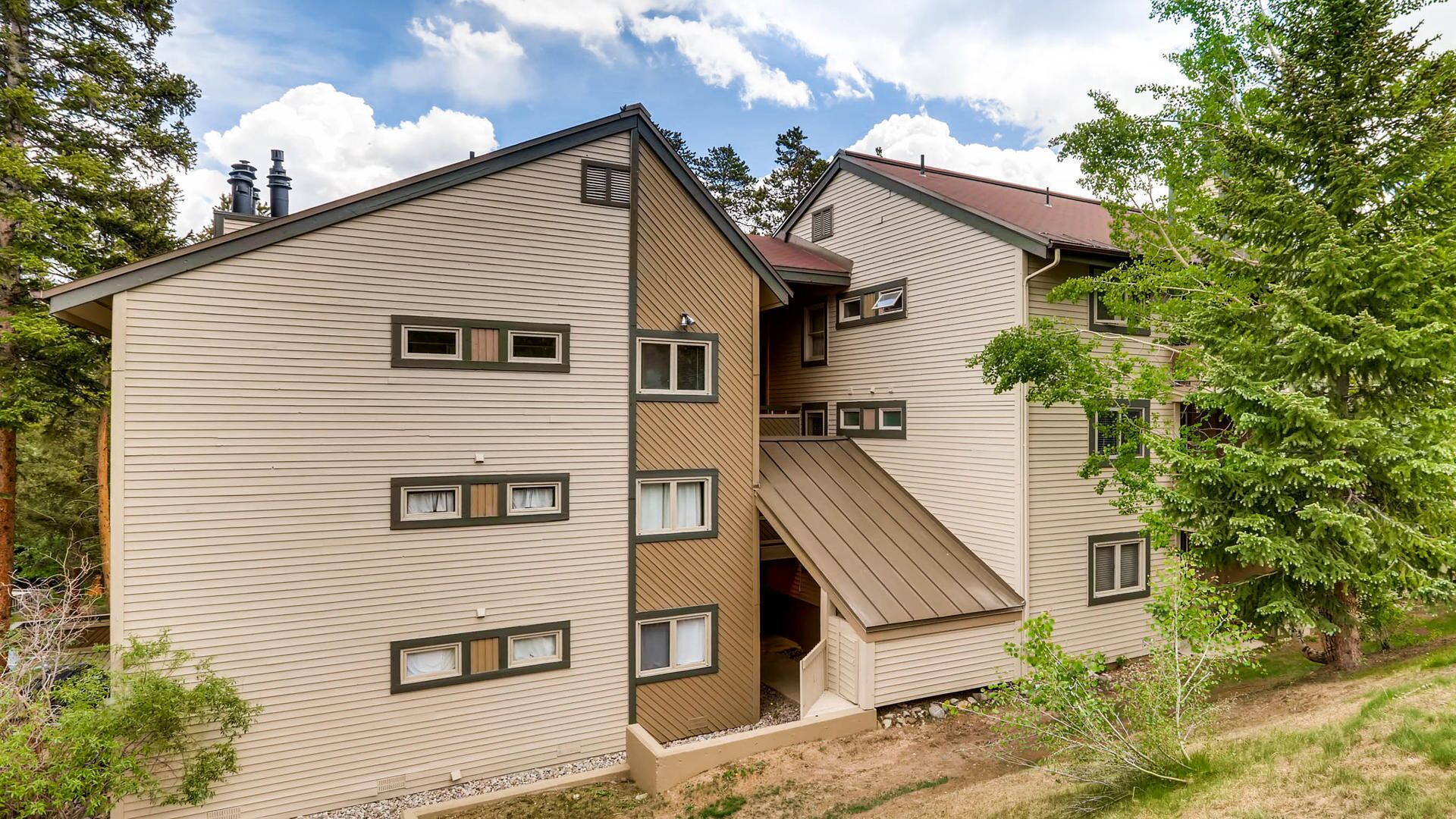 A two-story building with multiple windows and a sloped roof.