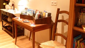 A room with a wooden desk, a chair, a bookshelf, and two framed pictures on the wall. - La Ferme de Marpalu (La Ferte-Saint-Cyr)