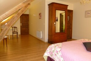 Ein Schlafzimmer mit einem hölzernen Bett, einem Schminktisch und einer Heizung.