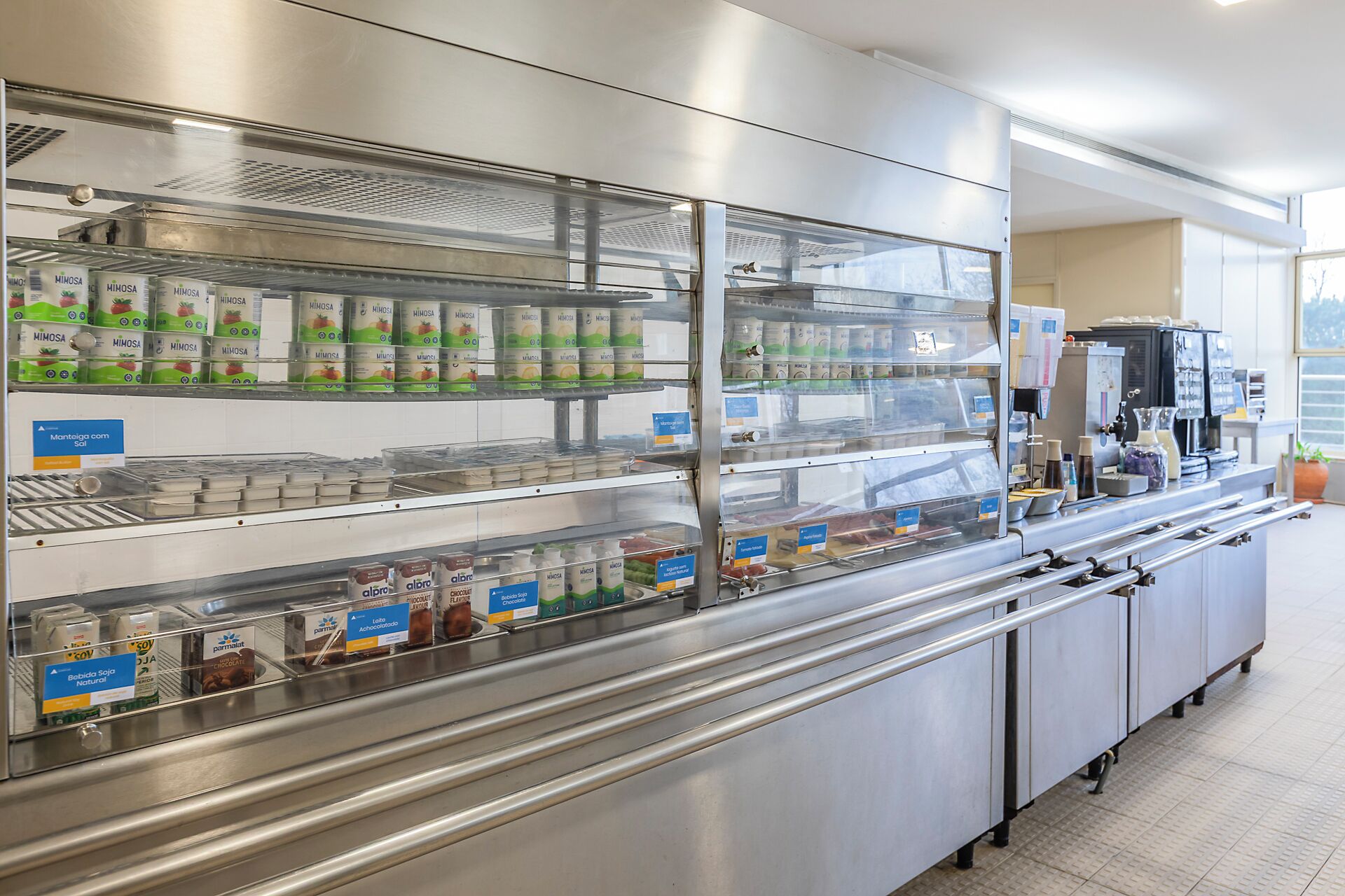 A bakery display with various packaged goods and a coffee machine.