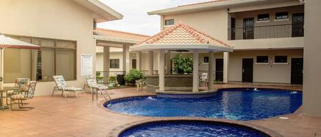 2 outdoor pools, open 7:00 AM to 5:00 PM, pool umbrellas, pool loungers