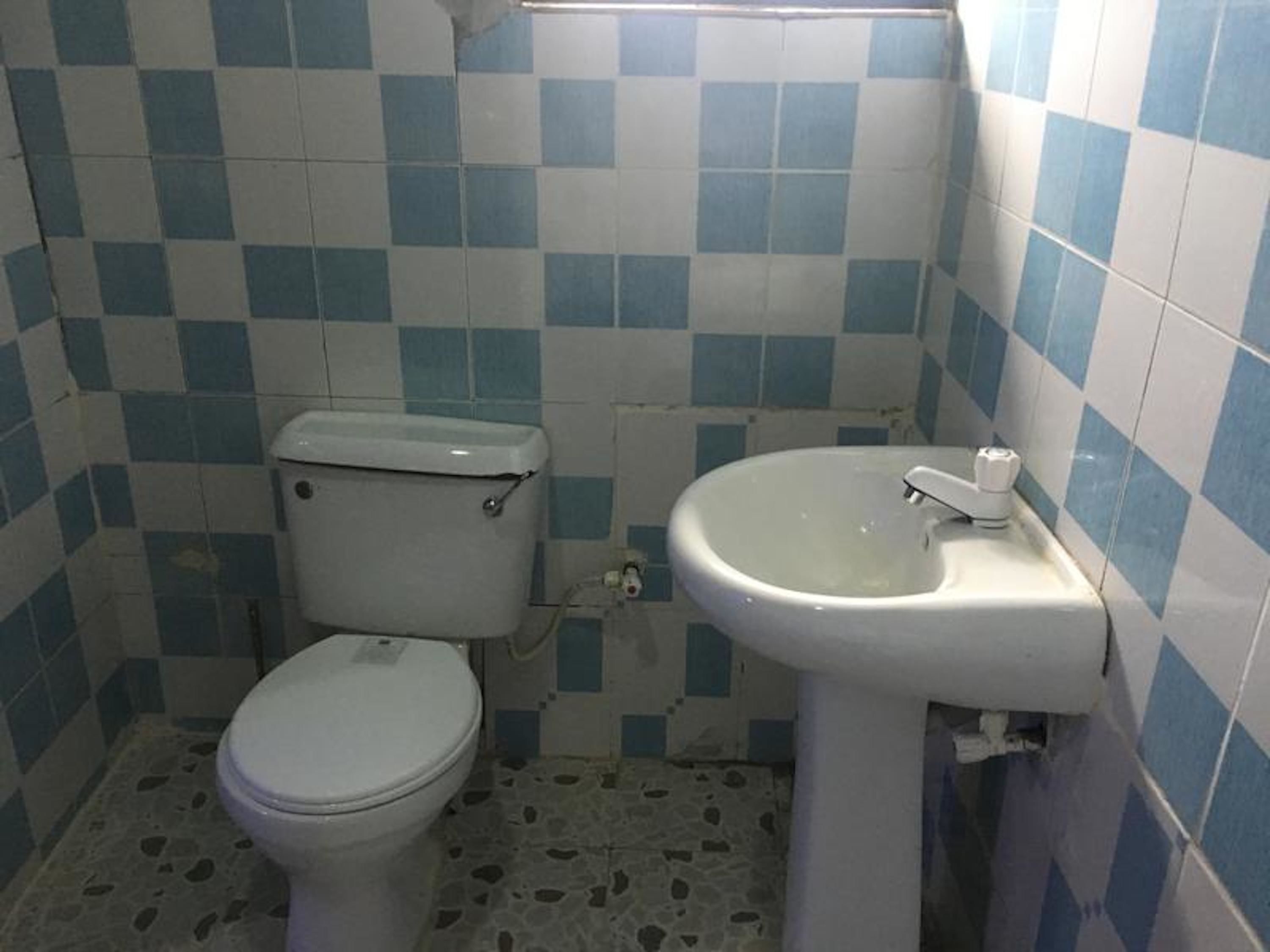 A small bathroom with a toilet and a sink.