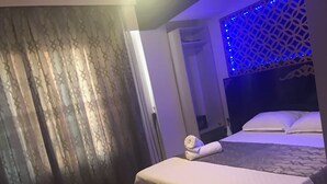 A hotel room with a bed, a small table, and a curtain. - Fairytale Hotel (Istanbul)
