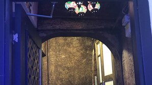 A staircase with a textured wall and a decorative sign above. - Fairytale Hotel (Istanbul)