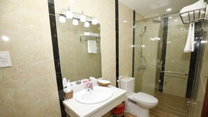 A modern bathroom with a glass-enclosed shower, a white sink, and a toilet. - Orange Quy Nhon (Quy Nhon Nam)
