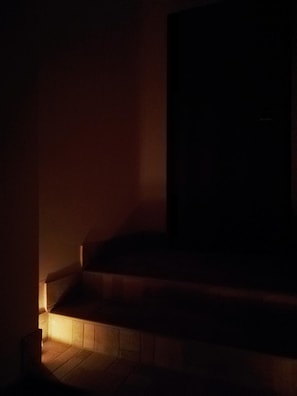 A dark staircase with a warm light at the bottom, leading to a dark room. - Bed and Breakfast Controtempo (Reggio Calabria)
