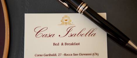 A business card for Casa Isabella, offering bed and breakfast services. The card includes the name, services, address, and contact information.