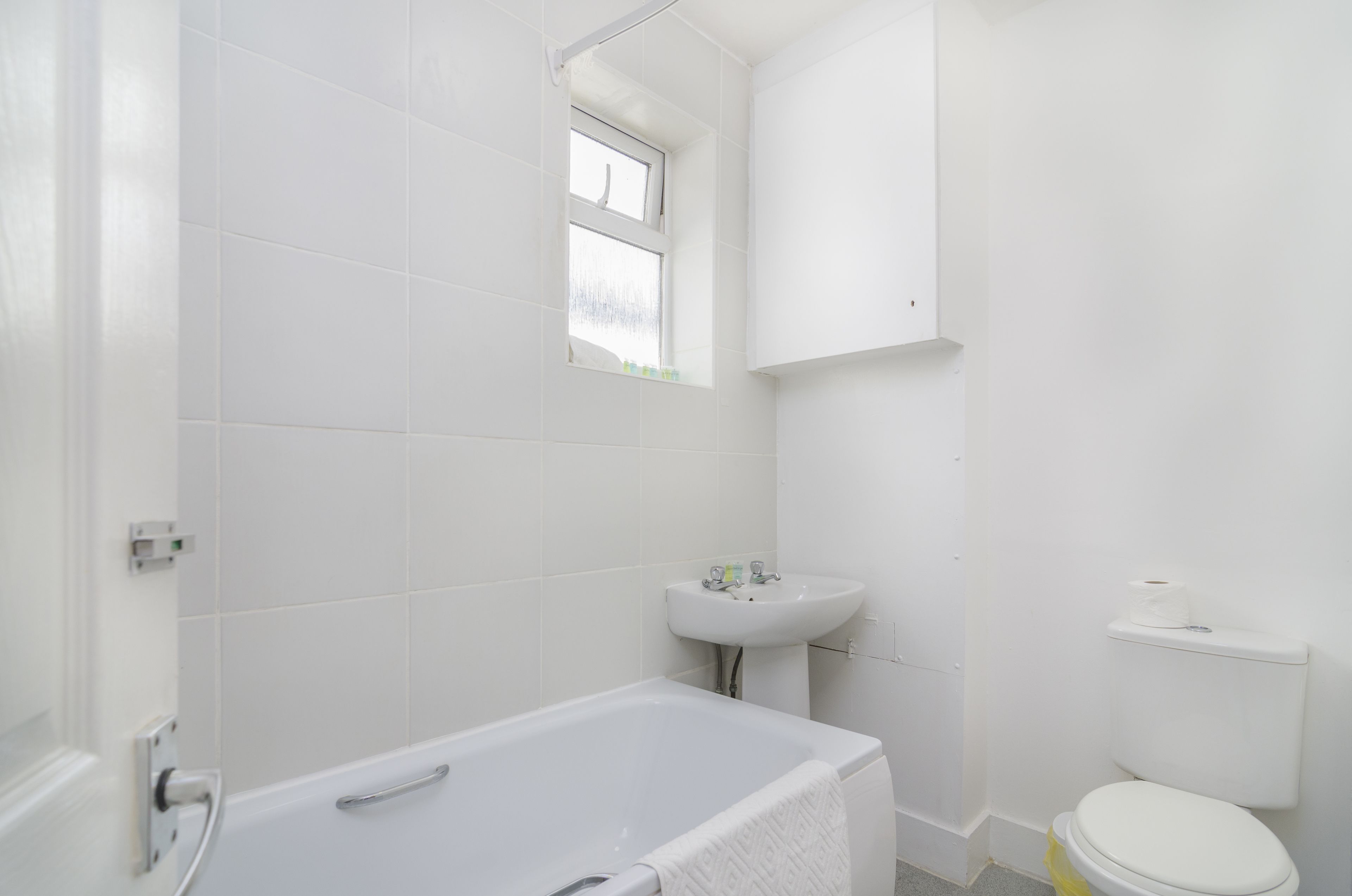 A bathroom with a bathtub, a sink, and a toilet.