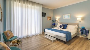 A bedroom with a bed, a chair, a bedside table, and a window with curtains. - B & B La Cornice - Gina Room With Bathroom and Private Terrace (San Gimignano)