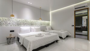 A modern hotel room with two beds, a large mirror, and a minibar. - Sunny Garden (Zakynthos)