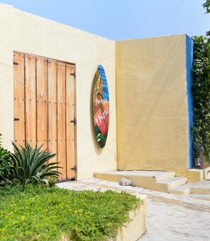 A building facade with a wooden door and a colorful sign.