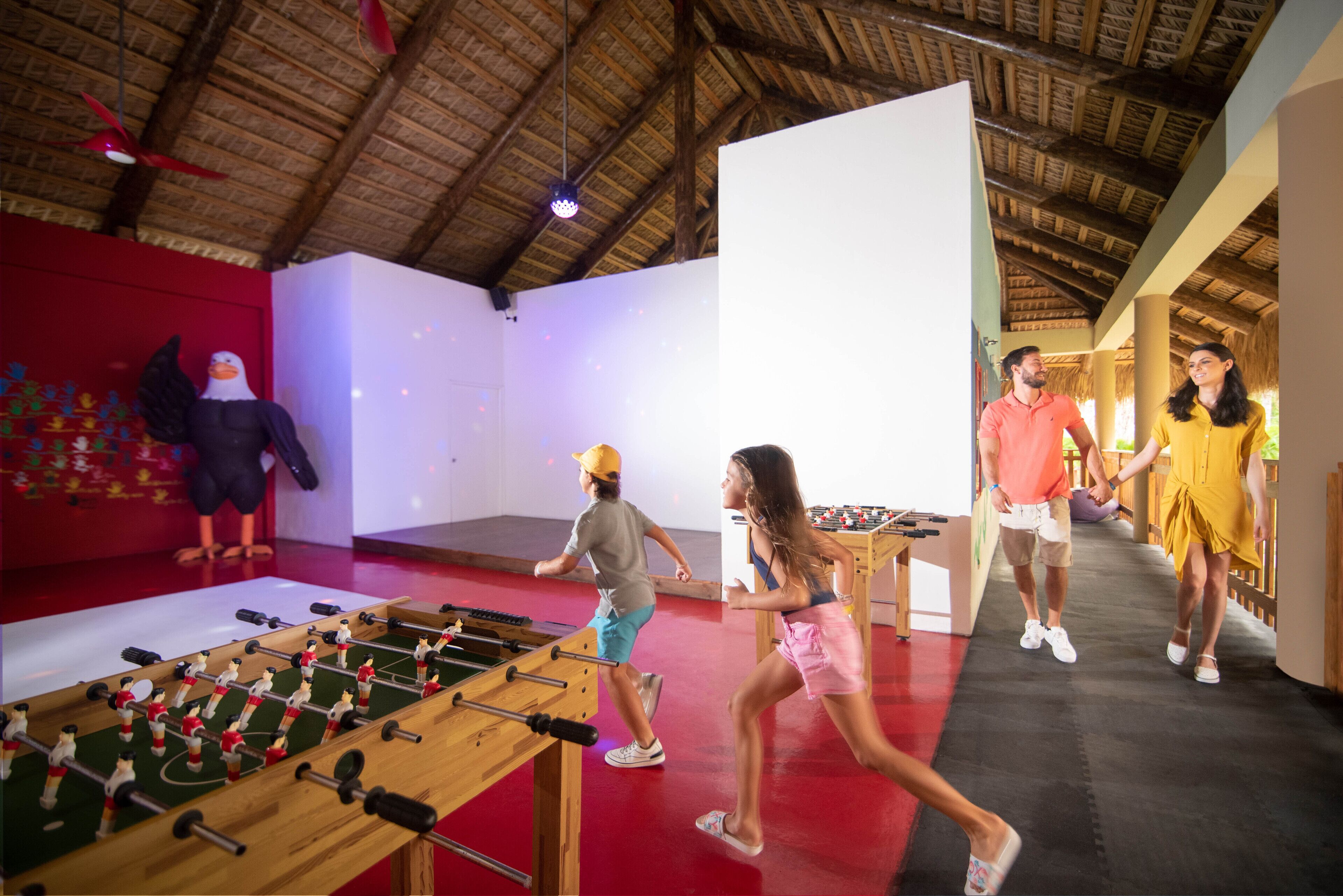 A room with a foosball table, a large whiteboard, and a mural of an eagle.