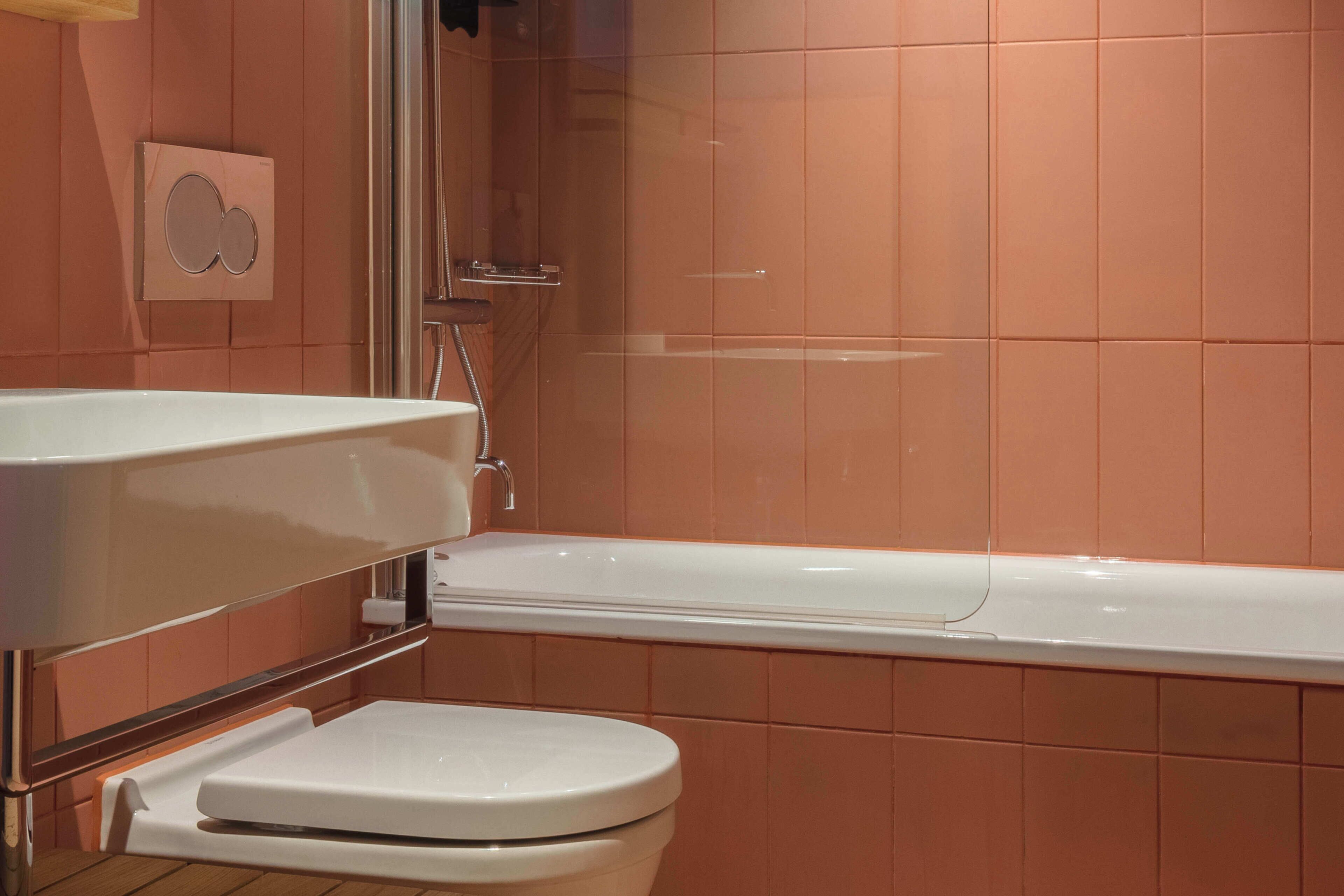 A bathroom with a white bathtub, a white toilet, and a white sink.