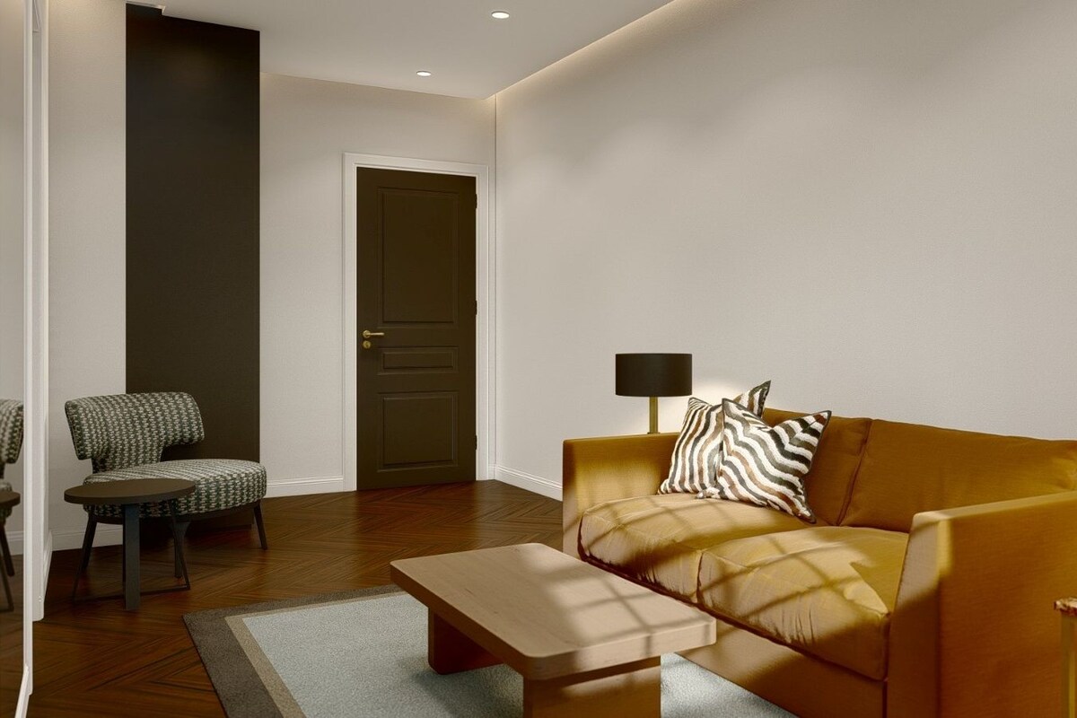 Un salon moderne avec un canapé, un fauteuil et une petite table.