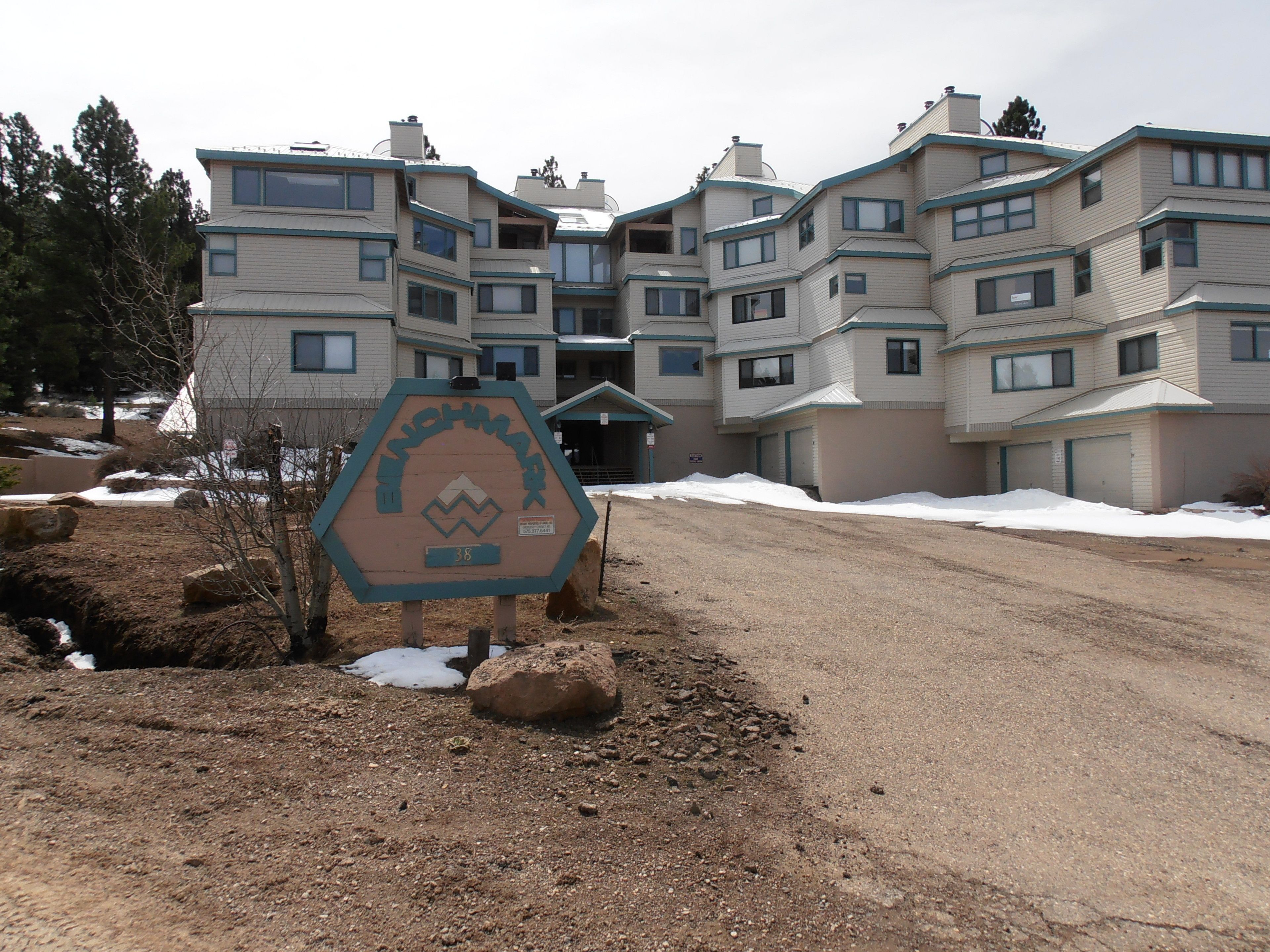 A multi-story building with a sign indicating the name and number of rooms.