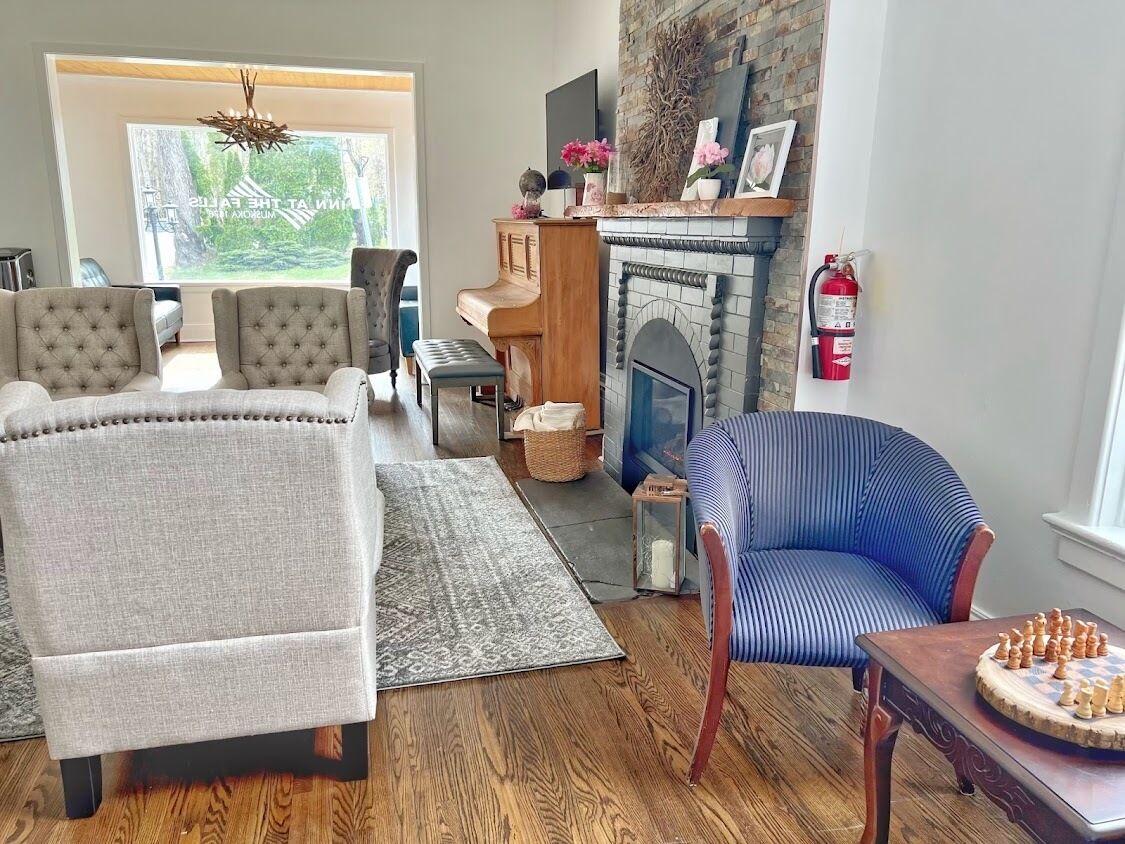 Ein Wohnzimmer mit Klavier, Kamin und Schachbrett.